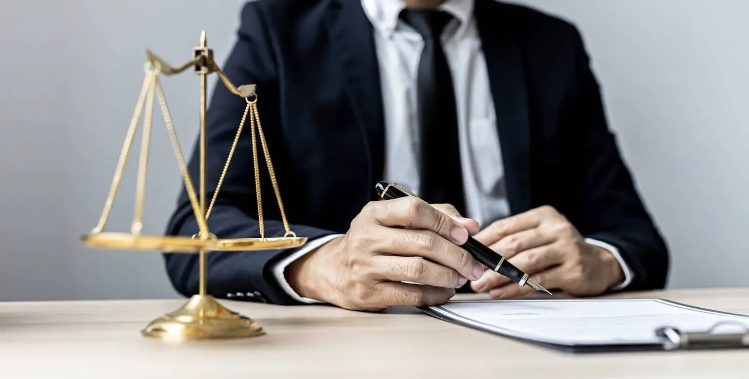 a-male-lawyer-is-signing-a-ple-1536x778.webp