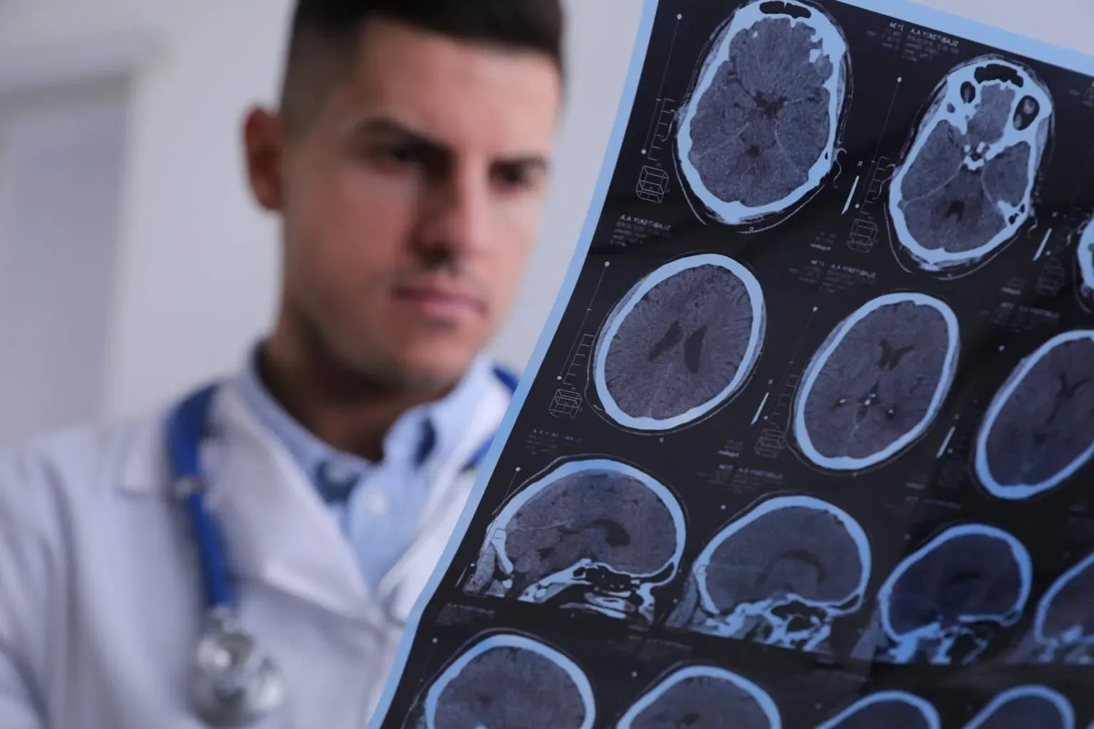 bigstock-Doctor-Examining-Mri-Images-Of-448167463-min