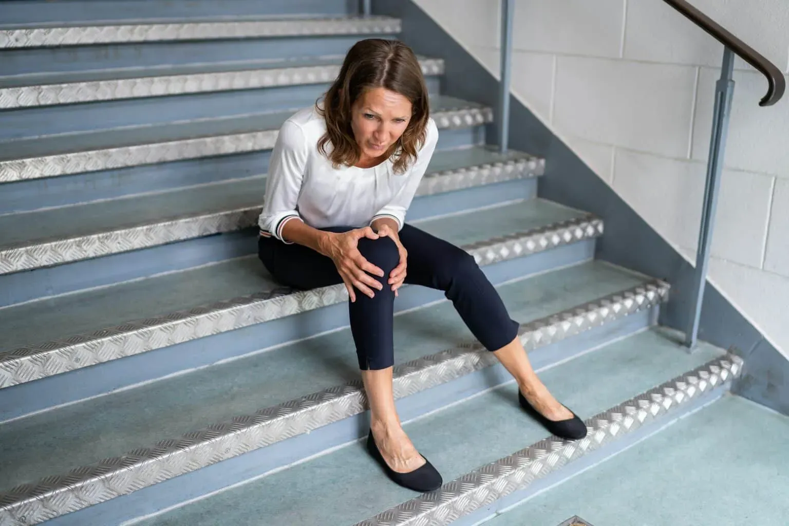 bigstock-Mature-Woman-Sitting-On-Stairc-456953337-min-1536x1024.webp