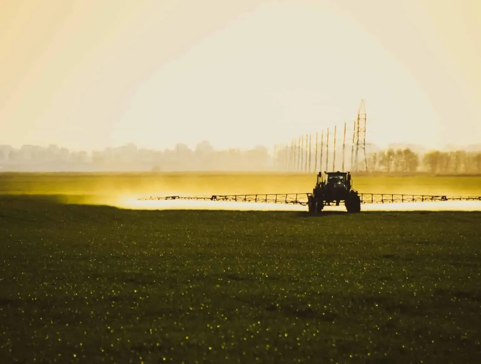 bigstock-Tractor-With-The-Help-Of-A-Spr-342975355-min-1536x1162.webp