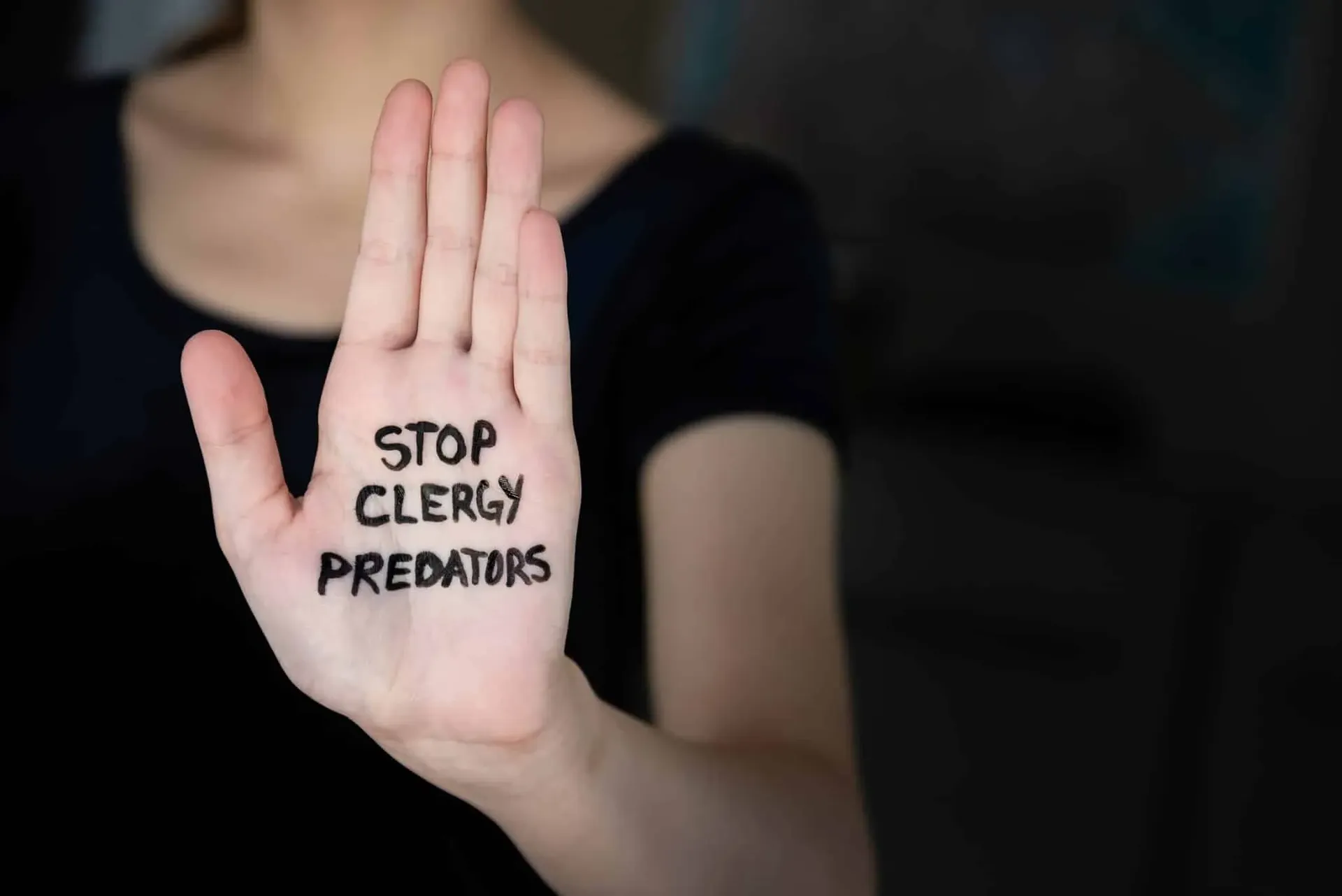 bigstock-Woman-In-Darkness-Holding-Hand-306005992-min