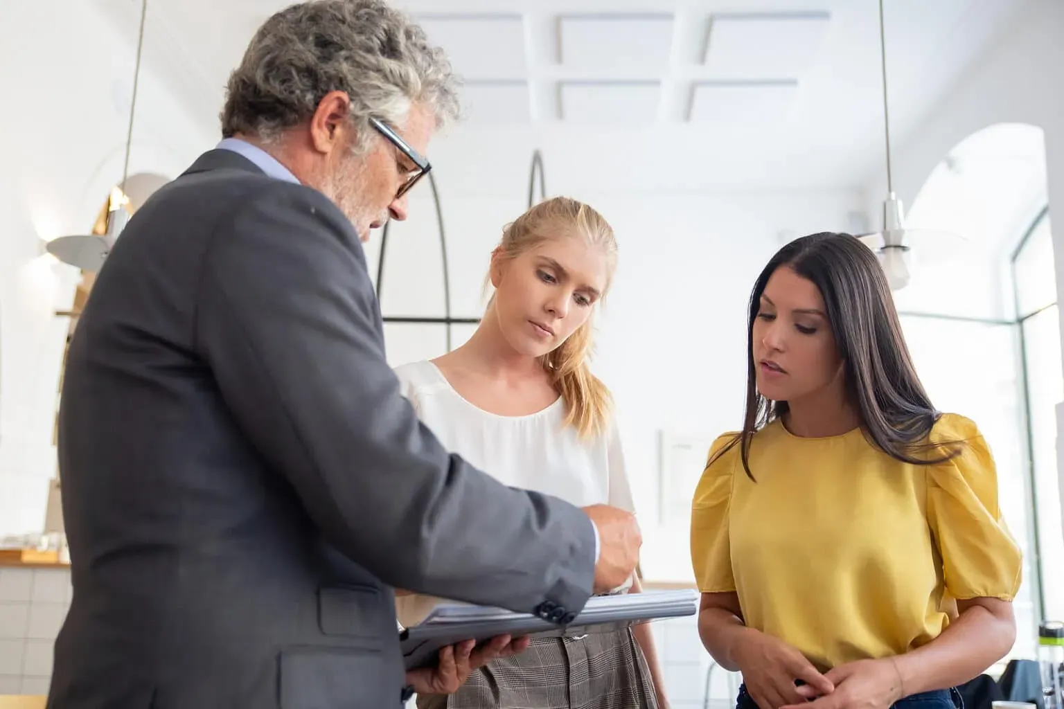 Serious male inspector with notepad meeting and discussing paper
